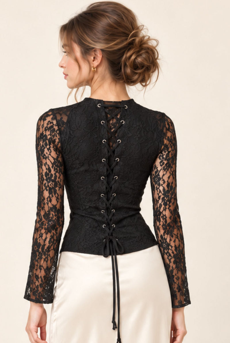 Close-up of the black floral lace corset-style lace-up back and long lace sleeves