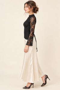 Side view of petite lace and satin dress showing the long cream skirt and flared lace sleeve