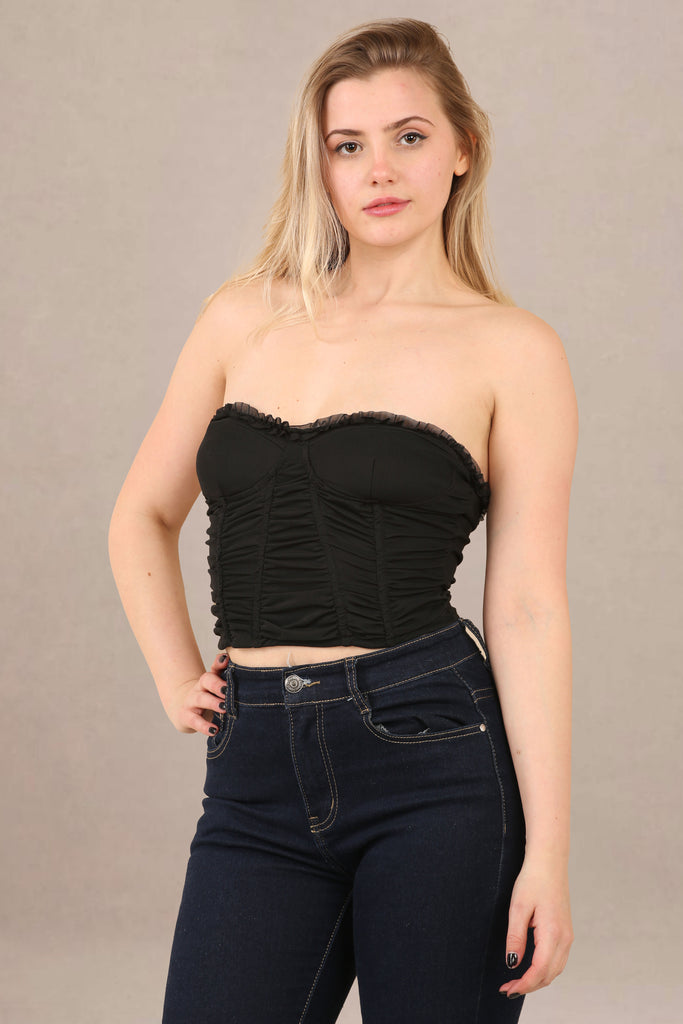 Close-up of slim leg denim jeans noir corset blouse co-ord