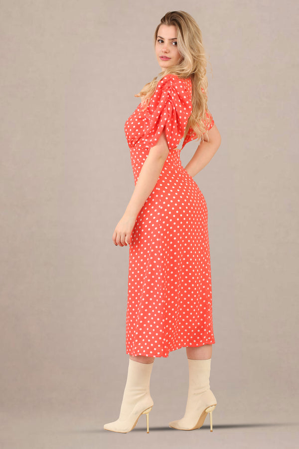 Side view of vintage-inspired puff sleeves polka dot midi dress
