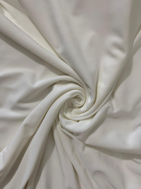 Close-up of white fabric with a swirl pattern